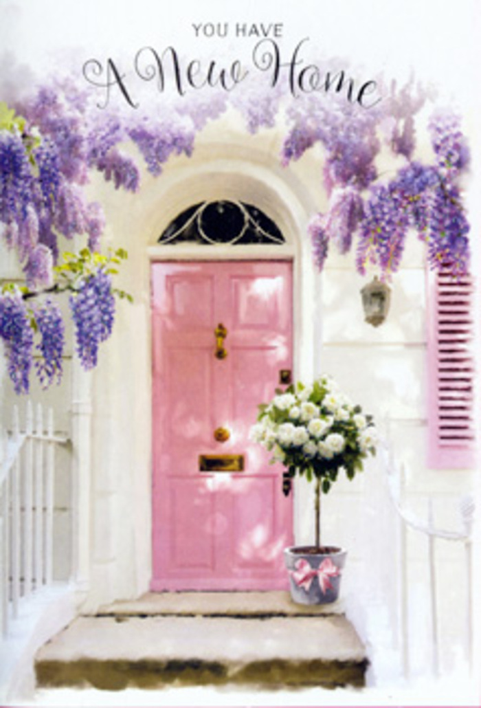 A serene, storybook-like entranceway unfolds in this scene, as if you were standing on a quiet residential lane in Chessington, pausing at the doorway of someone's first home. The front door is painted a soft, reassuring pink, its hue somewhere between blush and rose, and it sits within whitewashed walls that reflect the natural daylight with a clean, airy softness. A single pale shutter, brushed in matching pastel tones, hints at a cosy room beyond, catching just enough light to create a gentle contrast in texture and depth. Overhead, mature wisteria cascades from above the frame, its pendulous clusters of lavender blooms spilling down in fragrant curtains. The intertwined vines and soft green leaves form a natural arch, as though nature itself is blessing the entrance. Sunlight filters through these blossoms, casting feather-light patterns across the doorstep that shift with every passing breeze. On the step, a grey metal bucket has been styled as a charming vessel for a lush bouquet of white and cream roses. Each rose is fully formed and velvety, their layered petals cupping pockets of shadow that make them appear luxuriously full. Sprays of fresh greenery weave through the arrangement, offering a lively contrast of texture and a hint of garden freshness. Around the bucket's base, a pink ribbon, tied in a satin bow, mirrors the door colour and ties the composition together visually. The whole setting feels like a lovingly prepared house-warming surprise from a Chessington florist, perfect for welcoming a new neighbour or celebrating a recent move, filling the air with the soft promise of friendship, laughter, and the sense that this doorway will witness many happy arrivals.