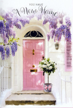 This image captures the feeling of arriving at a freshly painted home in Chessington on a bright, mild afternoon, perhaps just a short stroll from the leafy calm of Chessington Court Gardens. A pastel pink front door stands as the gentle focal point, its smooth surface glowing softly where the light touches it, while a matching shutter on the whitewashed wall brings a sense of harmony to the façade. Above the doorway, generous trails of wisteria tumble downward in cushions of lavender and lilac, the hanging blooms creating a fragrant, curtain-like arch that softens every edge. The sun filters through those petals and small green leaves, scattering delicate specks of light across the step so that the entrance seems to shimmer with quiet joy. Resting right at the threshold is a sturdy, stylish tin bucket in muted grey, the kind you might find in a well-loved local florist's studio. It's brimming with creamy white roses at the peak of their openness, each bloom plush and velvety, enriched by sprigs of fresh green foliage that peek between the petals. A soft pink ribbon is tied neatly around the bucket, its bow lying gracefully against the metal as a charming finishing touch that echoes the door colour. The whole arrangement looks like a thoughtfully delivered new-home gift, perhaps just brought to the doorstep by a Chessington florist for same-day delivery. With its pastel palette, gentle textures, and the mingled scents you can almost imagine, the scene quietly expresses congratulations, comfort, and the tender promise of new memories yet to unfold behind that pink door.